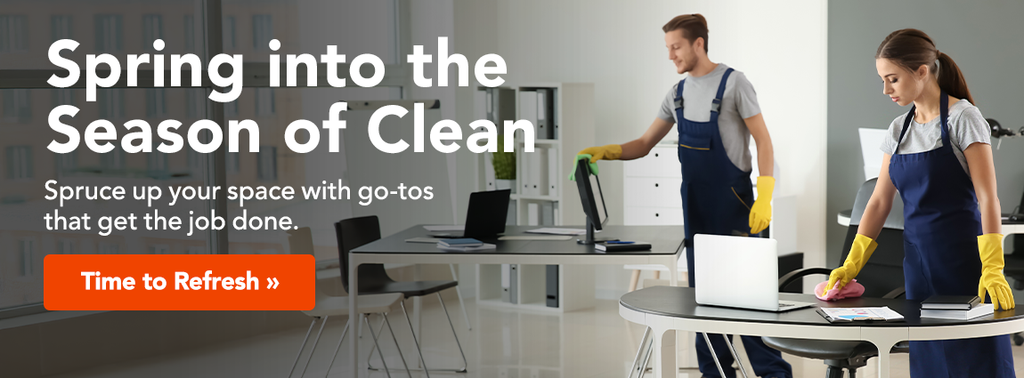 Two people in blue overalls and yellow rubber gloves clean an office space. Text reads: Spring into the season of . Spruce up your space with the go-tos that get the job done. A button reads refresh your space.